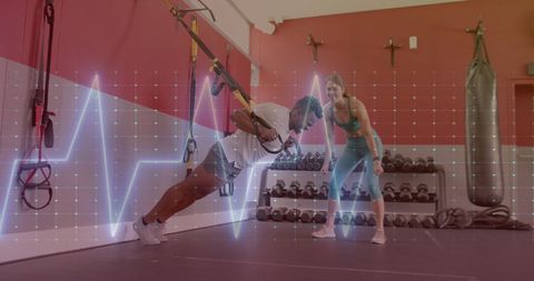 Dynamic Duo Exercising with Digital Monitoring in Gym - Download Free Stock Images Pikwizard.com