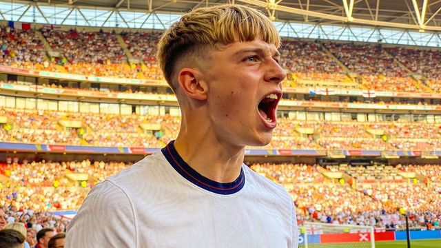 Young male fan shouting passionately in packed stadium during soccer match