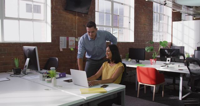 Colleagues Collaborating in Modern Office with Brick Walls and Large Windows - Download Free Stock Images Pikwizard.com