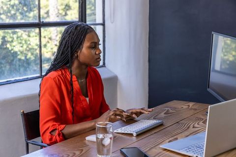 Focused professional woman typing at modern workspace