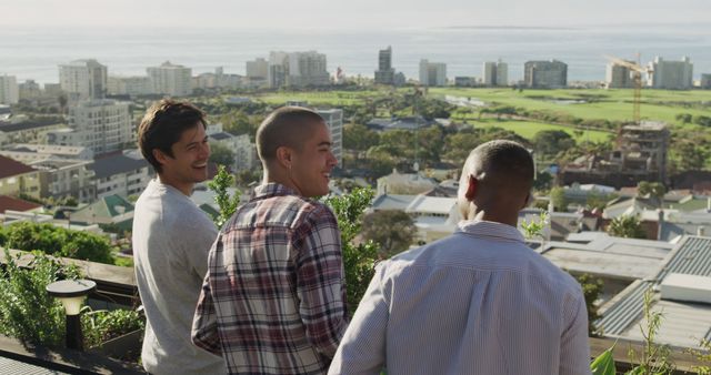 Three Friends Enjoying Scenic City View from Rooftop Terrace - Download Free Stock Images Pikwizard.com