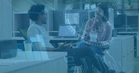 Colleagues Collaborating in Open Office with Futuristic HUD Overlay and Circuit Graphics