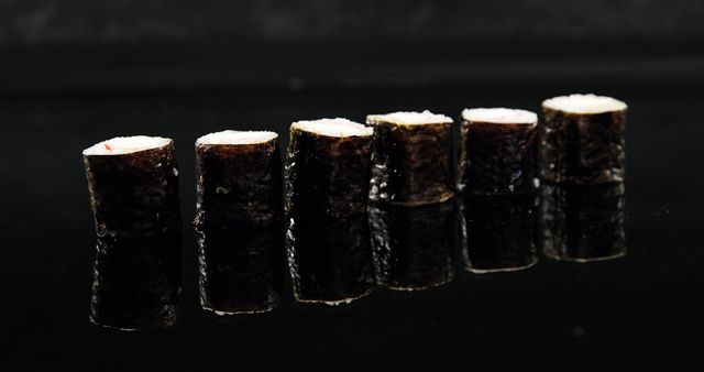Close-Up of Six Sushi Rolls Reflected on Black Surface - Download Free Stock Photos Pikwizard.com