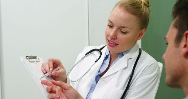 Doctor Discussing Medical Report with Patient in Clinic - Download Free Stock Images Pikwizard.com