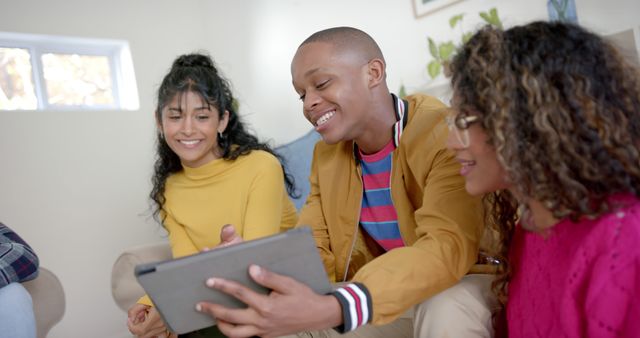 Diverse Group of Young Friends Enjoying Tablet Together - Download Free Stock Images Pikwizard.com