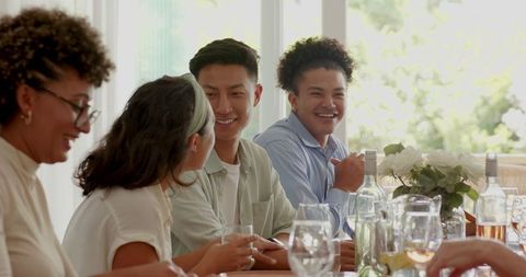 Friends Enjoying Wedding Reception with Toasts and Laughter