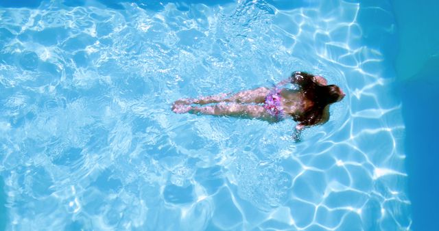 Person Swimming in Clear Blue Pool Water from Above - Download Free Stock Images Pikwizard.com