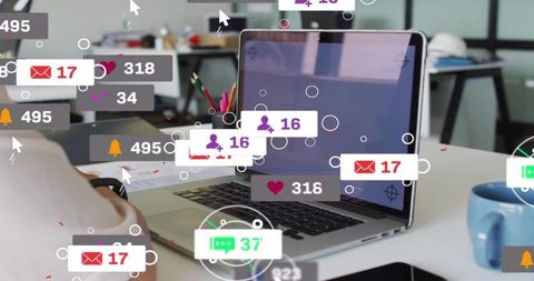 Laptop showing floating social media notifications and metrics on modern coworking desk