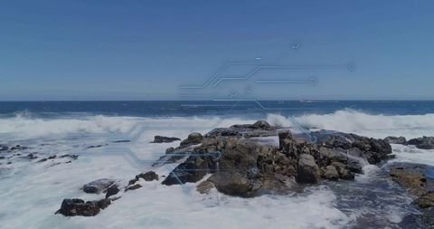 Waves Crashing on Rugged Rock Outcrop with Ocean Horizon View