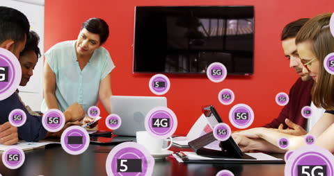 Coworkers Collaborating with 5G Technology on Digital Devices