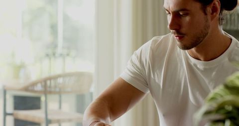 Focused Man Working on Laptop at Home in Calm Environment