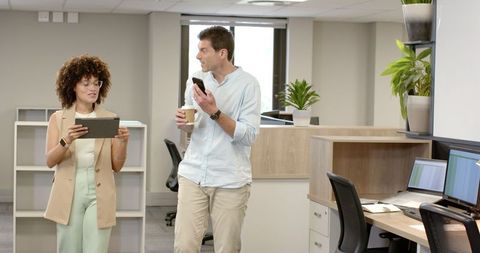 Colleagues Collaborating in Modern Open-Plan Office