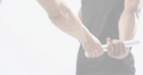 Gripping metal bar behind back showing veined forearms muscular strength