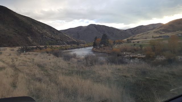 Serene River Flowing Through Mountain Valley at Sunset - Download Free Stock Photos Pikwizard.com