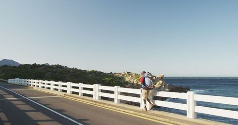Man with Prosthetic Leg Trekking by Ocean Bridge - Download Free Stock Images Pikwizard.com