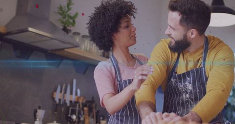 Cheerful Diverse Couple Enjoying Baking Together in Kitchen