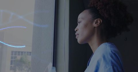 Contemplative African American Nurse in Hospital Corridor