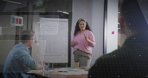 Confident Businesswoman Leading Strategy Presentation in Modern Office