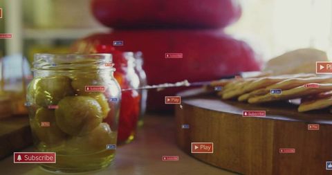 Rustic kitchen still life with jarred pickles, cheeses, crackers and social media overlays