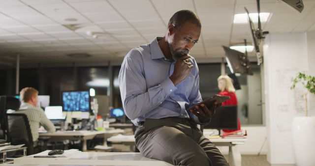 Pensive African-American Businessman Working Late in Office - Download Free Stock Images Pikwizard.com