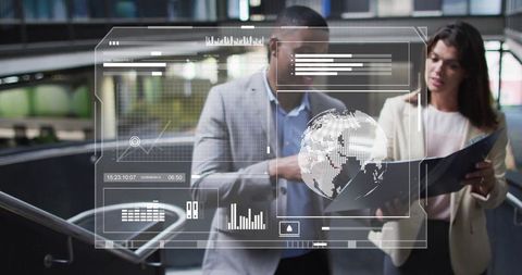 Two professionals analyzing data overlay in contemporary office