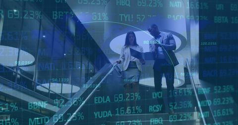 Two Businesspeople Analyzing Financial Data in Modern Office