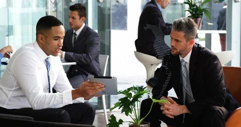 Business Professionals in Modern Office Discussing Strategy