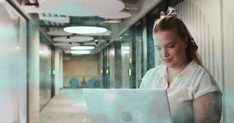 Businesswoman Working on Laptop in Corridor with Modern Design