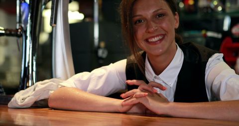 Cheerful Waitress Leaning on Bar Smiling Warm Hospitality - Download Free Stock Images Pikwizard.com
