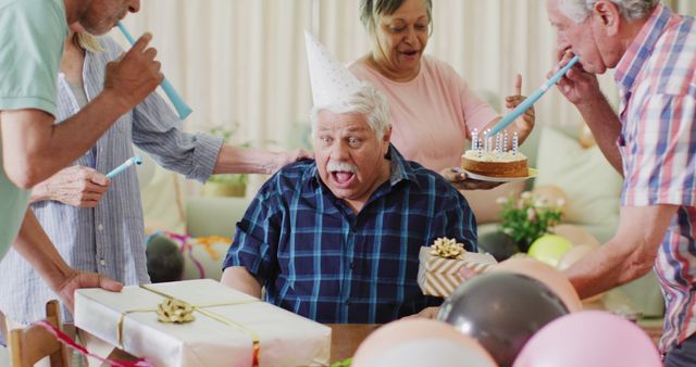 Senior Man Joyfully Celebrating Birthday with Friends - Download Free Stock Images Pikwizard.com