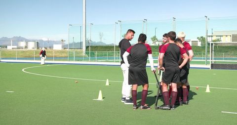 Male Field Hockey Team Receiving Training on Turf Pitch
