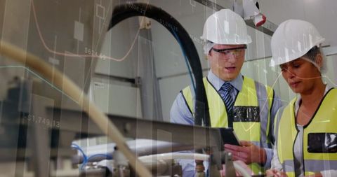 Industrial Workers Analyzing Data in Manufacturing Facility