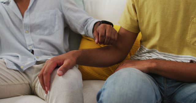 Close-up View of Two People Holding Hands on Sofa - Download Free Stock Photos Pikwizard.com