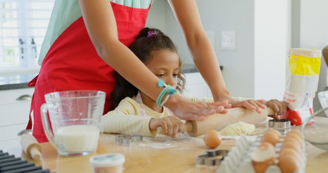 Mother Helping Daughter Rolling Dough in Kitchen - Download Free Stock Images Pikwizard.com