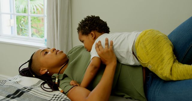 Mother Relaxing on Bed with Child Sharing Tender Moment at Home - Download Free Stock Images Pikwizard.com