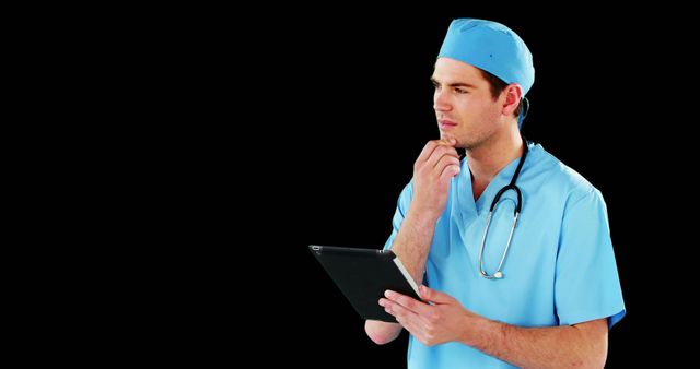 Young Doctor in Scrubs Using Tablet with Black Background - Download Free Stock Images Pikwizard.com