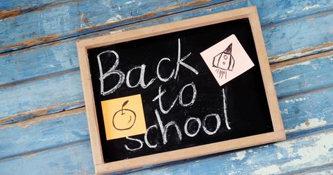 Back to school chalkboard on blue wooden background