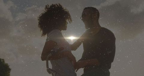 Romantic Silhouette of Expecting Couple at Sunset with Bicycle