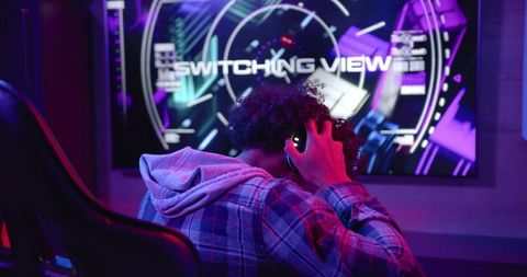 Gamer Immersed in Video Game with Headphones in Tech-Infused Room