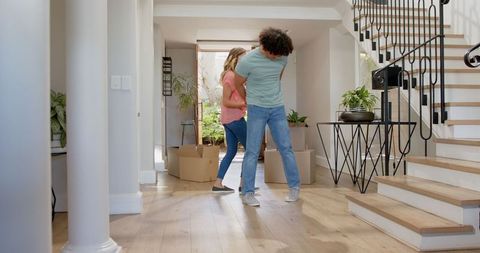 Happy Young Couple Embracing Homeownership in New House