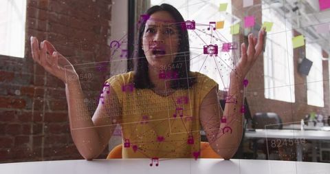 Presenting woman gesturing through augmented reality network interface in loft workspace