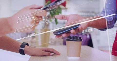 Customer Tapping Smartphone for Contactless Payment at Coffee Counter with Cashier