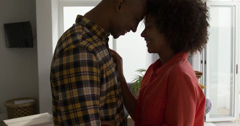 Happy Couple Embracing in Sunlit Living Room