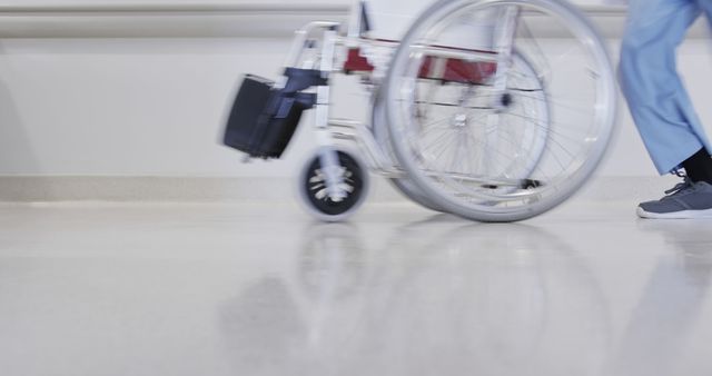 Hospital Staff Wheeling Empty Wheelchair Through Corridor - Download Free Stock Images Pikwizard.com