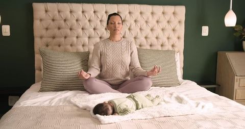 Mother Practicing Mindfulness Near Sleeping Infant