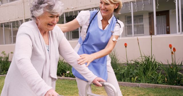 Elderly woman using walker assisted by nurse in care facility garden - Download Free Stock Images Pikwizard.com