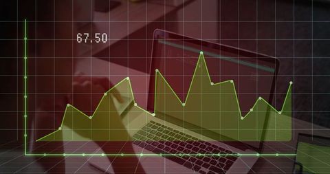 Analyzing data graph on laptop with tools at modern workspace