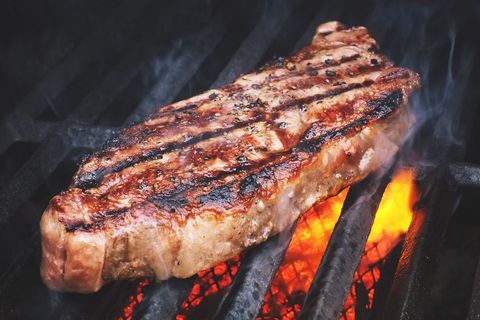 Juicy Grilled New York Strip Steak Seared Over Open Flame with Smoky Char Marks