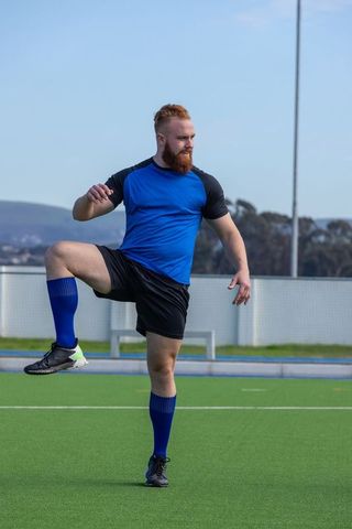 Athlete Balancing on Synthetic Field in Outdoor Training Session