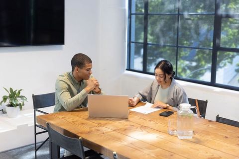 Diverse Coworkers Collaborating at Modern Office Meeting Table